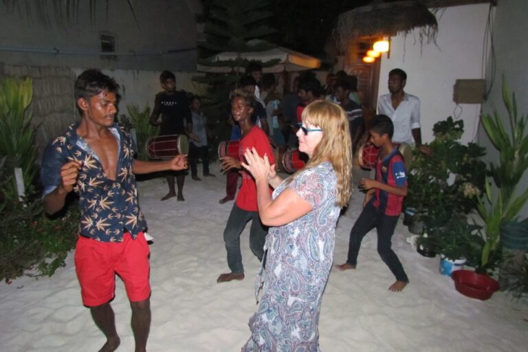 people dancing in the sandy courtyard of the hotel