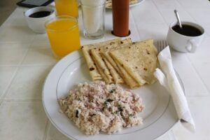 risotto and two cups with coffee and orange juice