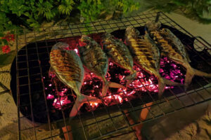 Grilled fish over oiled coals in the grill