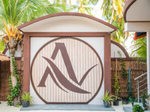 Large hotel logo on the very wall in front of the entrance door.