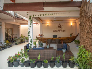 Light reception with rattan seating and greenery.