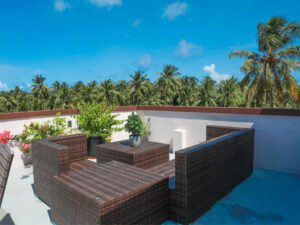 Rattan sofa on the terrace overlooking the palm trees
